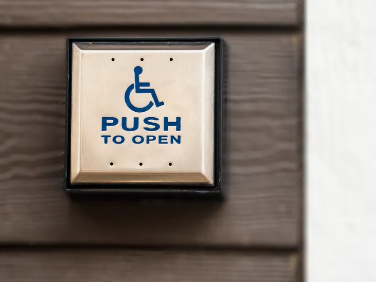 Accessible push-to-open door button