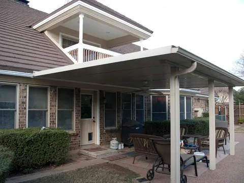 Covered patio addition on a brick home