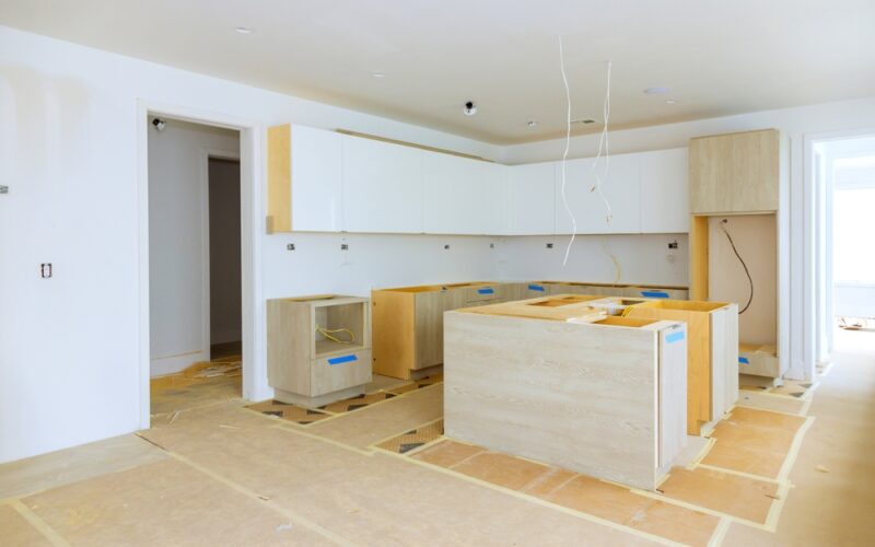 Installing,New,Custom,Kitchen,Cabinet,During,Construction,Of,Home,Improvement